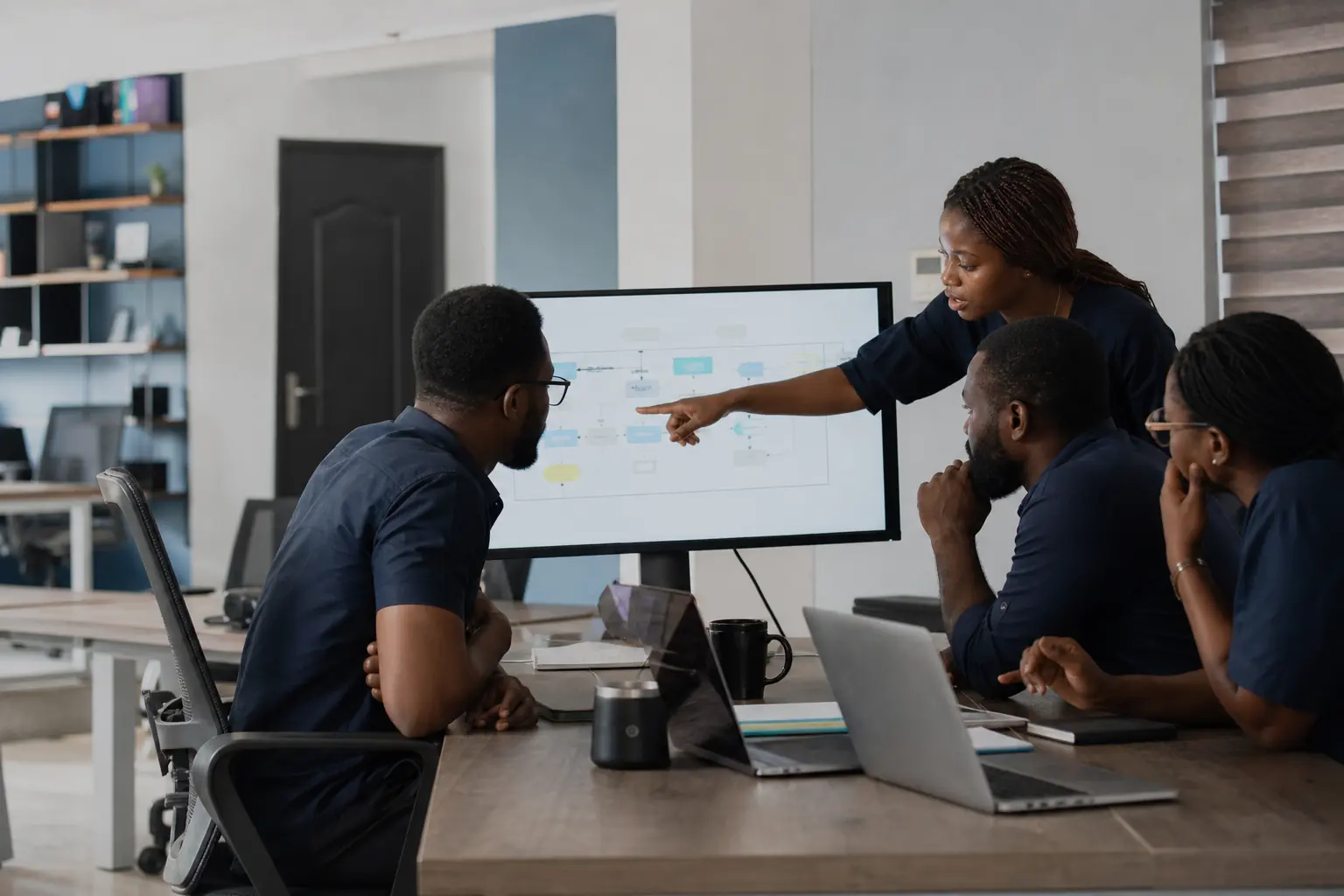 Conceptual editorial image of Nigerian software professionals reviewing a product workflow; the people shown are not presented as Appnovia employees.